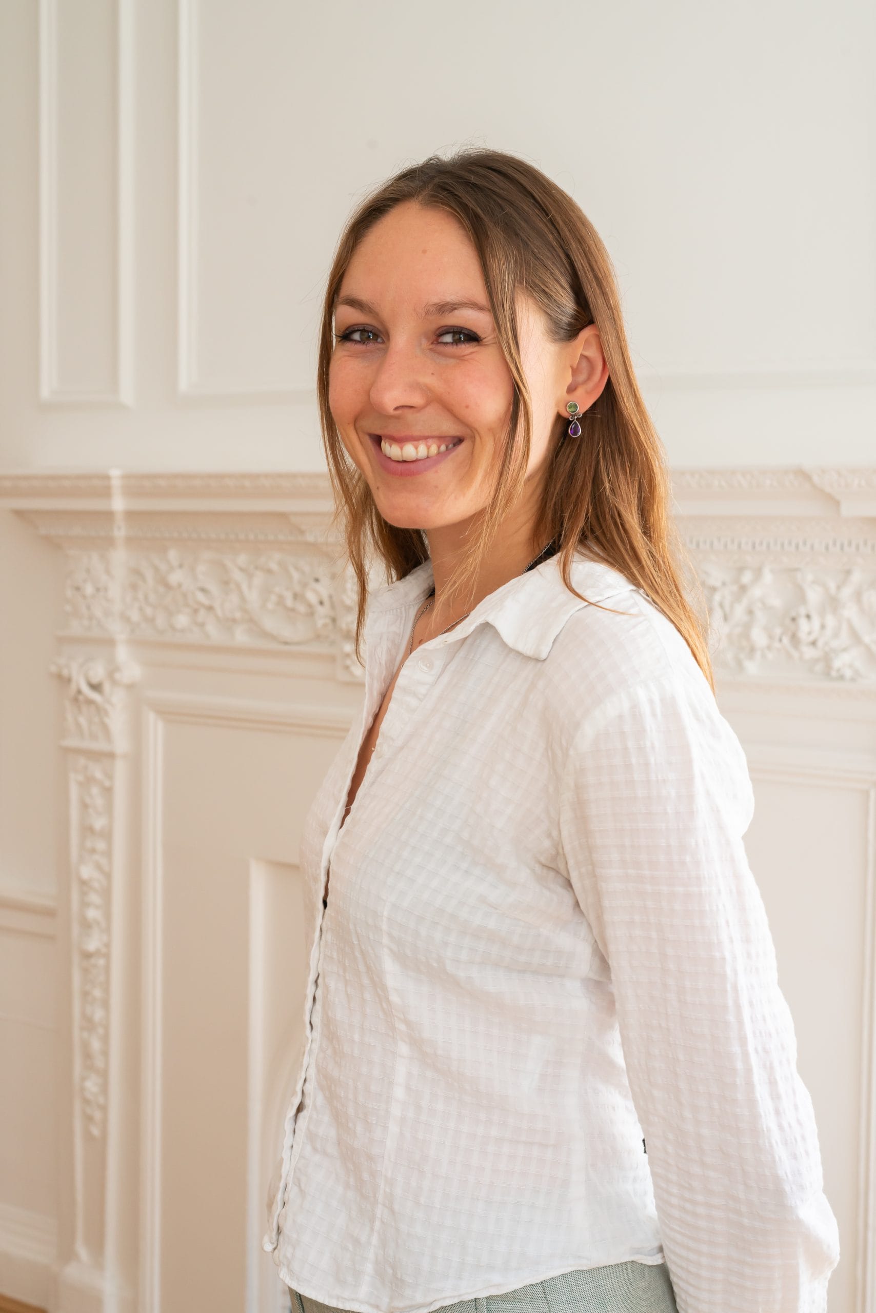 Image: Emily Taplin, Researcher, BOP Consulting, standing in the BOP offices.